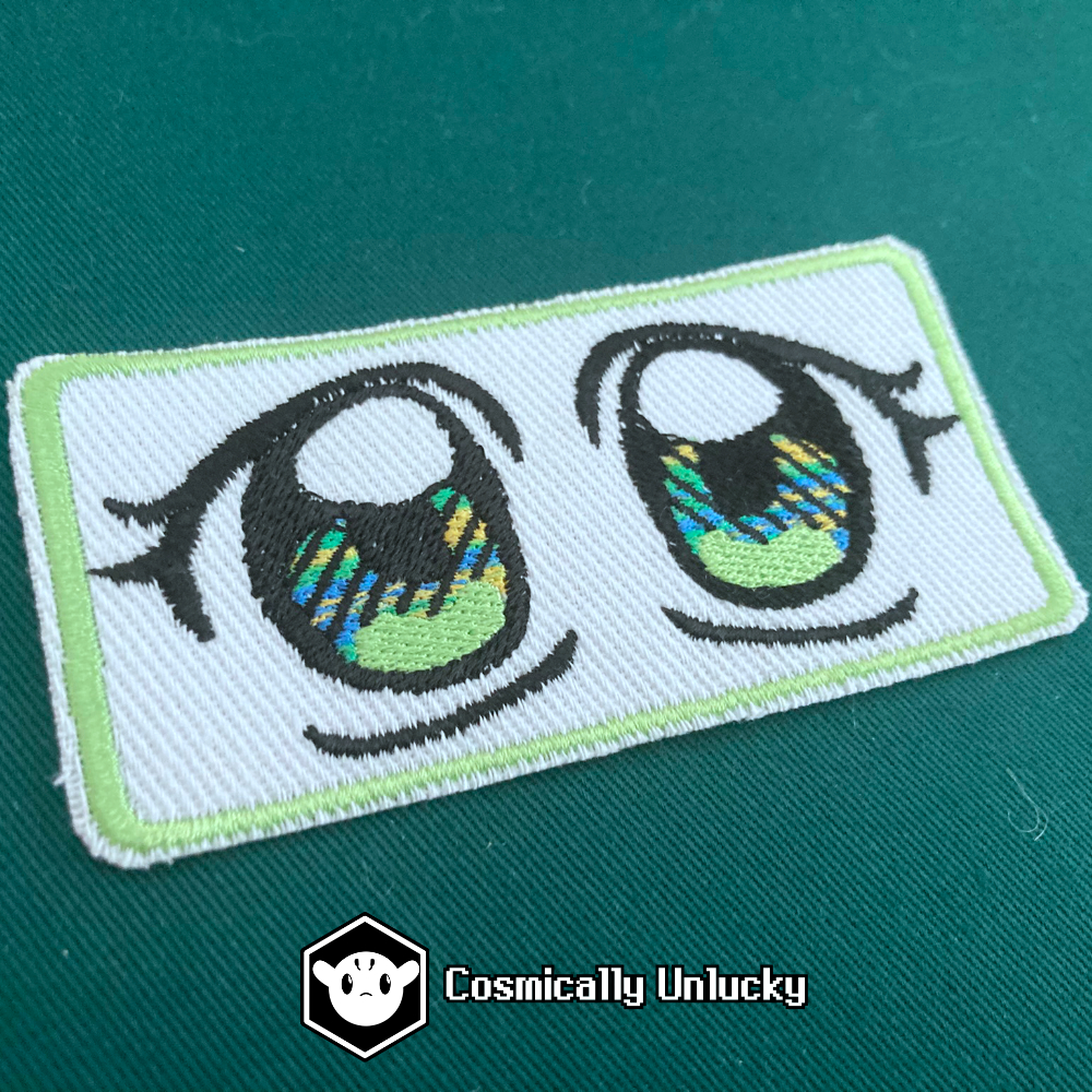 A photograph of anime eyes as an embroidered patch